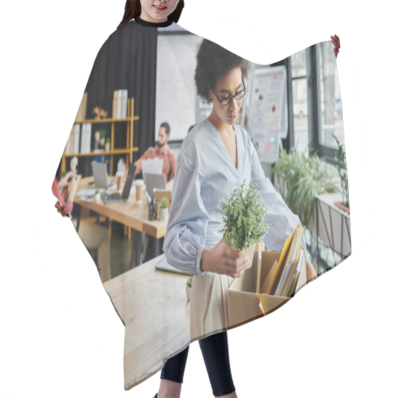 Personality  Good Looking African American Woman Packing Her Items During Lay Off, Colleagues On Backdrop. Hair Cutting Cape