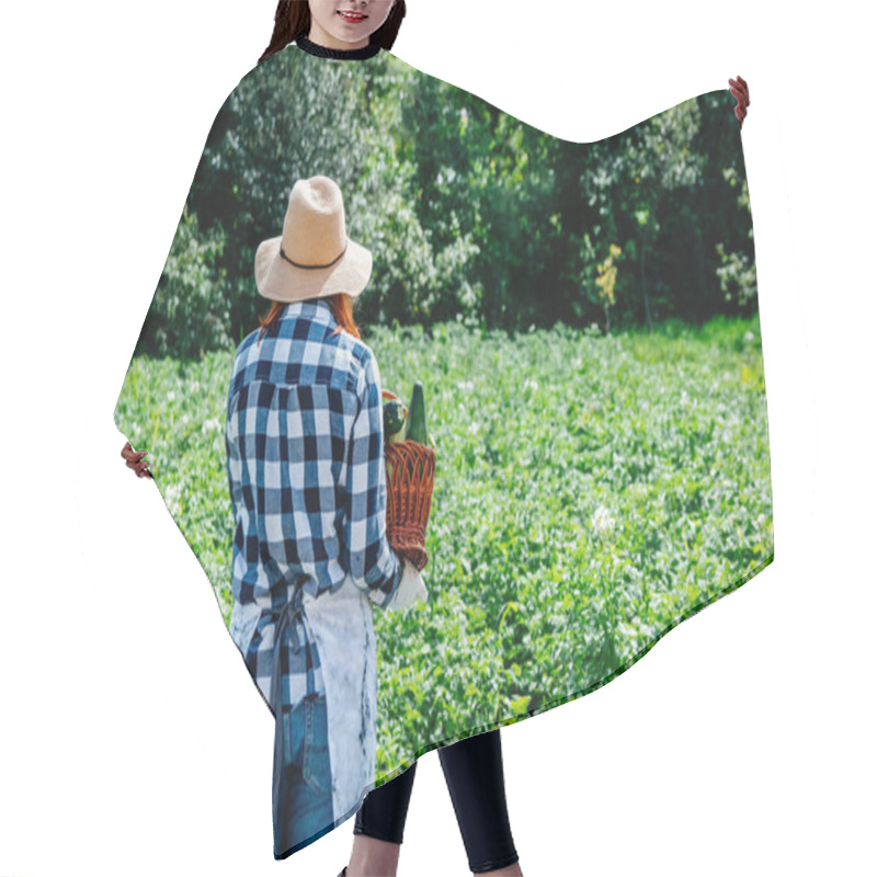 Personality  Portrait Beautiful Female Farmer Holds A Zucchini In A Wicker Basket Wearing A Straw Hat And Surrounded By The Many Plants In Her Vegetable Garden. Hair Cutting Cape