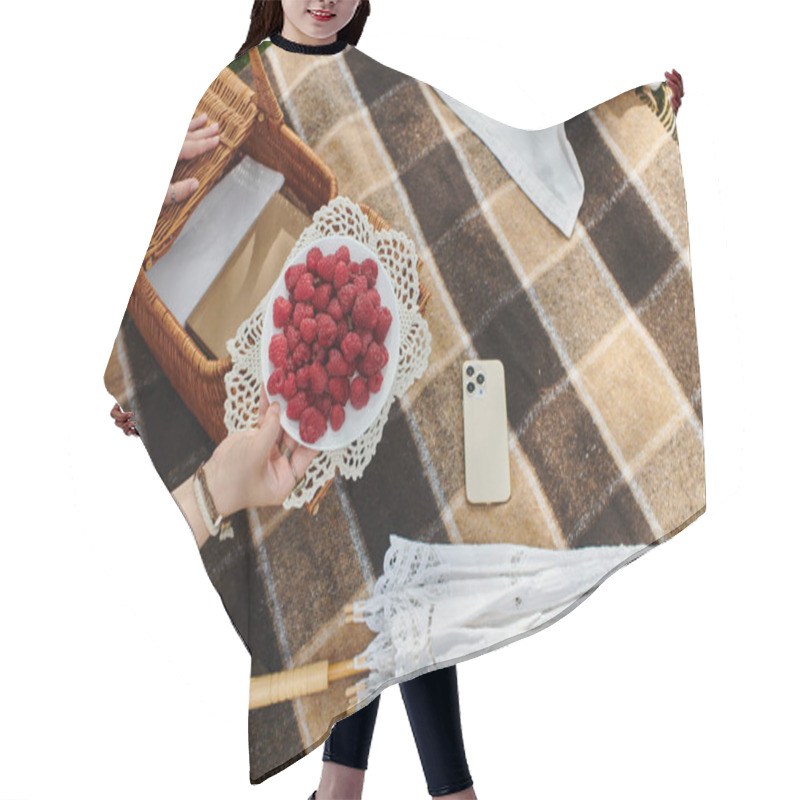 Personality  A Young Woman In A White Shirt Relaxes During A Summer Picnic, Savoring Fresh Raspberries On A Blanket. Hair Cutting Cape