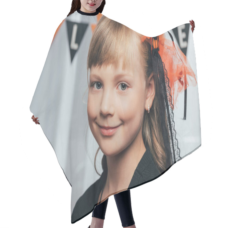 Personality  Portrait Of Adorable Smiling Kid Looking At Camera Wit Halloween Flags Hanging Behind At Home Hair Cutting Cape