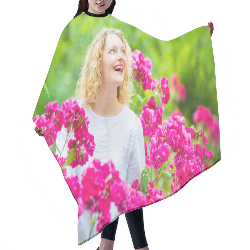 Personality  Beautiful Woman With Spring Blooming Rose Flowers. Young Smiling Girl Enjoys Pink Rose Flowers. Summer Time. Happy Woman Walking At Rose Garden. Pink Rosebush Blooming. Hair Cutting Cape