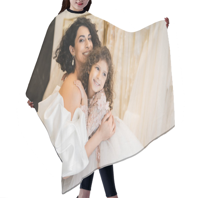 Personality  Charming Middle Eastern Bride With Brunette Hair In White Wedding Dress With Puff Sleeves And Ruffles Embracing Positive Daughter In Bridal Store, White Tulle Fabrics On Blurred Background  Hair Cutting Cape