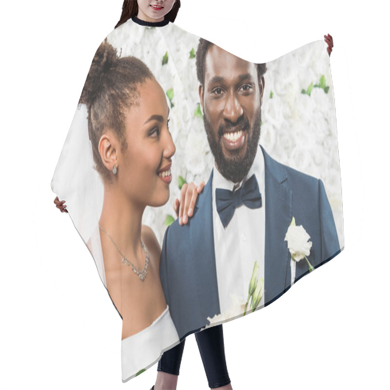 Personality  Happy African American Bride Looking At Bridegroom Holding Flowers  Hair Cutting Cape