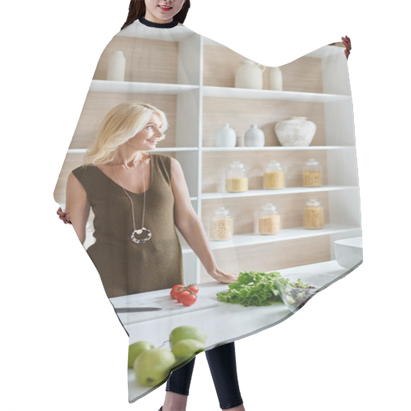 Personality  Happy Blonde Middle Aged Woman Standing Next To Countertop With Fresh Ingredients And Cutting Board Hair Cutting Cape