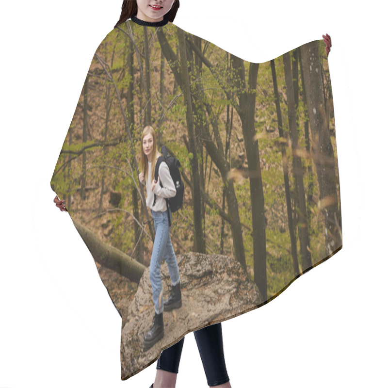 Personality  Blond Calm Pretty Woman Hiker With Backpack Walking Through A Forest Looking At Camera Hair Cutting Cape