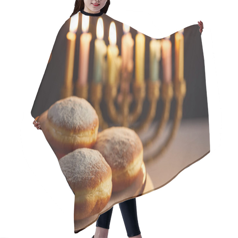 Personality  Selective Focus Of Delicious Doughnuts On Stand Near Glowing Candles In Menorah On Black Background With Bokeh Lights On Hanukkah Hair Cutting Cape