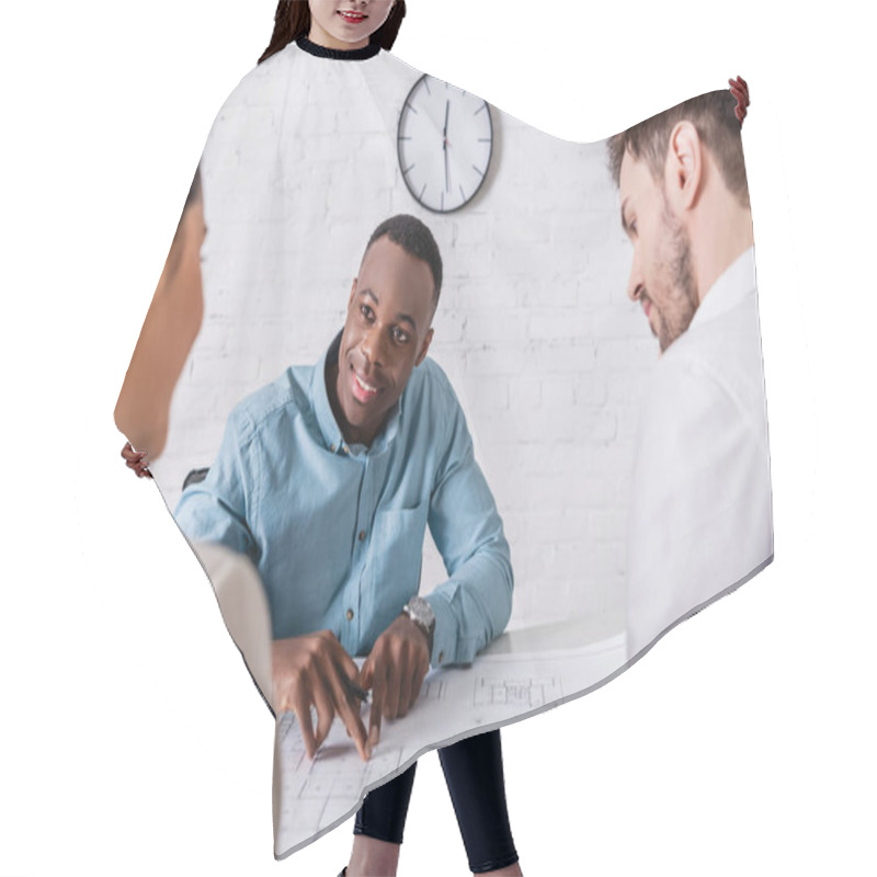 Personality  Smiling African American Businessman Pointing At Blueprint While Looking At Business Partner Near Translator On Blurred Foreground Hair Cutting Cape