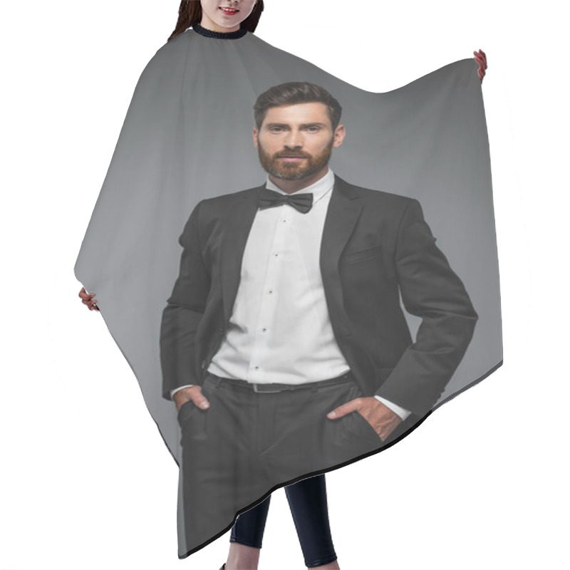 Personality  Bearded Man In Elegant Tuxedo With Bow Tie Posing With Hands In Pockets Isolated On Grey  Hair Cutting Cape