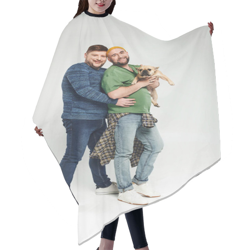 Personality  A Loving Gay Couple Standing Together, Holding A French Bulldog. Hair Cutting Cape