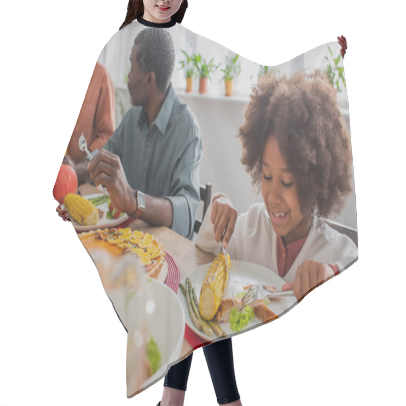 Personality  African American Girl Having Thanksgiving Dinner Near Blurred Grandpa And Brother Hair Cutting Cape