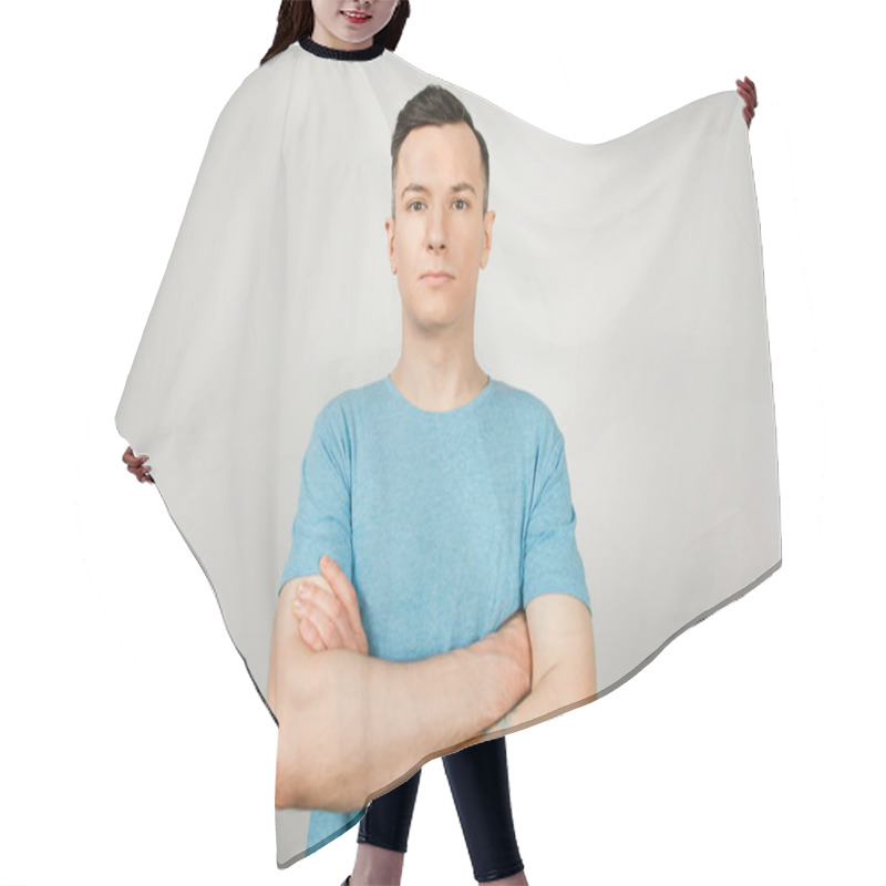 Personality  Young Guy Dressed In A Blue T-shirt On A Light Background. Closeup Portrait. Hair Cutting Cape