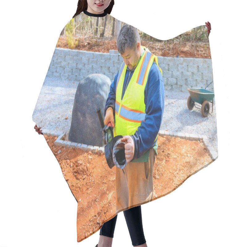 Personality  Worker Wearing Safety Vest Is Cuts Off Part Of Drainage Pipe Before Installation At During Construction Site Hair Cutting Cape