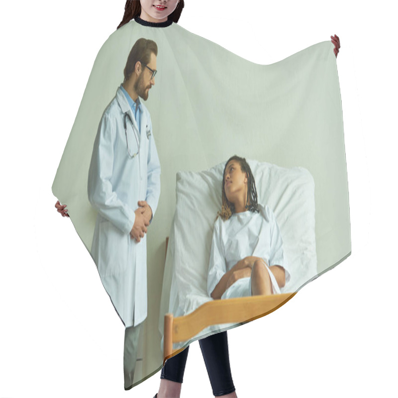 Personality  Bearded Doctor Standing Near African American Woman In Hospital Gown, Private Ward, Patient Hair Cutting Cape