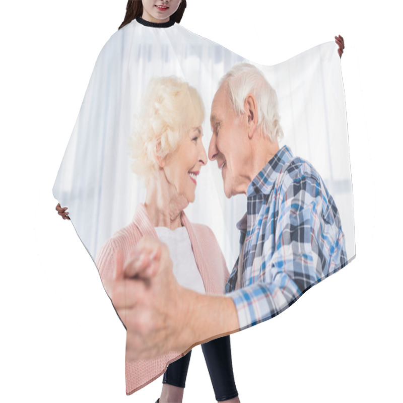 Personality  Side View Of Smiling Senior Couple Dancing Together At Home Hair Cutting Cape