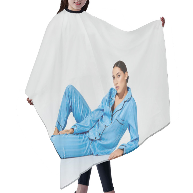 Personality  Relaxed And Confident, A Beautiful Woman Showcases Her Chic Blue Sleepwear While Lounging. Hair Cutting Cape