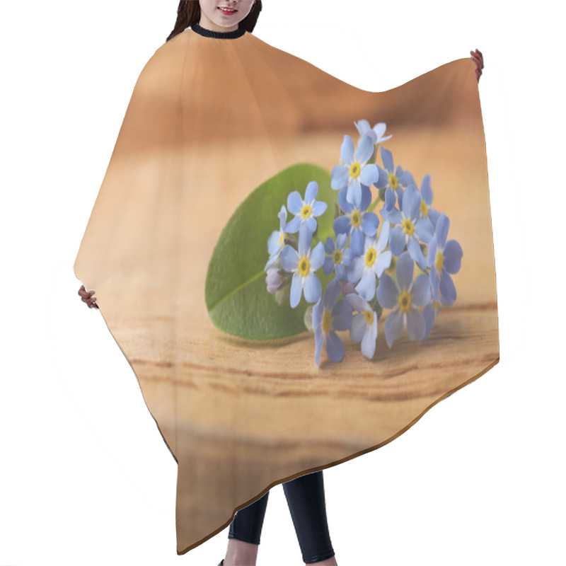 Personality  Beautiful Blue Forget-me-not Flowers On Wooden Table, Closeup. Space For Text Hair Cutting Cape