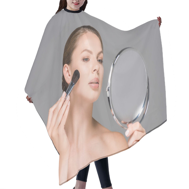 Personality  Portrait Of Young Woman Looking At Mirror And Applying Blush Isolated On Grey Hair Cutting Cape