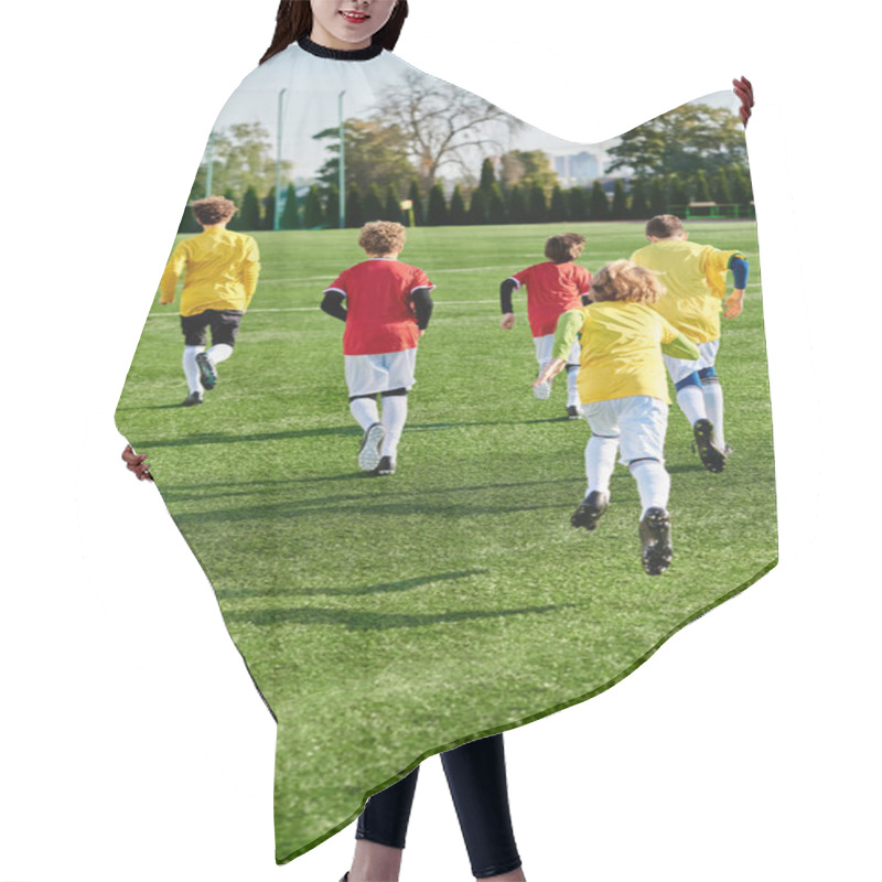 Personality  A Lively Group Of Young Children Enthusiastically Playing A Game Of Soccer On A Green Field, Kicking The Ball, Running, Cheering, And Displaying Teamwork And Sportsmanship. Hair Cutting Cape