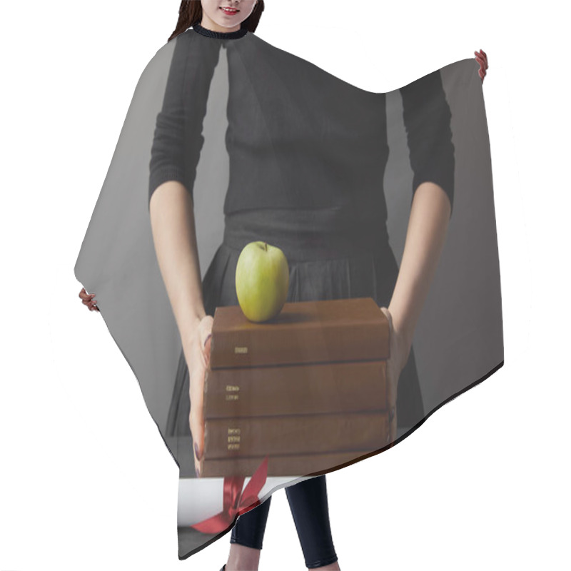 Personality  Cropped View Of Woman Holding Brown Books And Green Apple Near Diploma On Grey Hair Cutting Cape