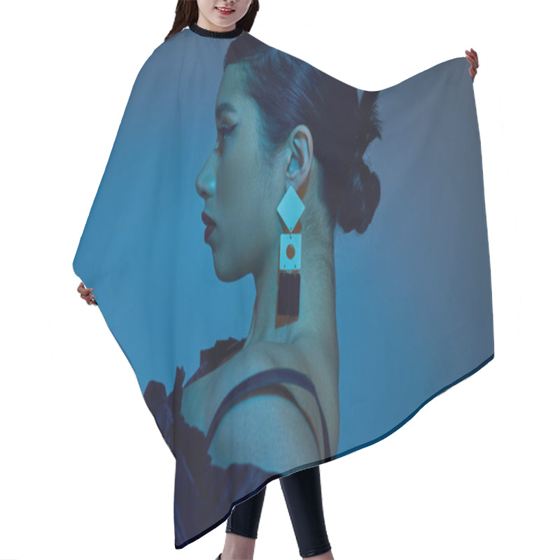 Personality  Spring Fashion Photography, Profile Asian Woman With Brunette Hair, Bold Makeup, Trendy Hairstyle And Earring On Blue Background With Cyan Lighting Effect, Generation Z, Side View  Hair Cutting Cape