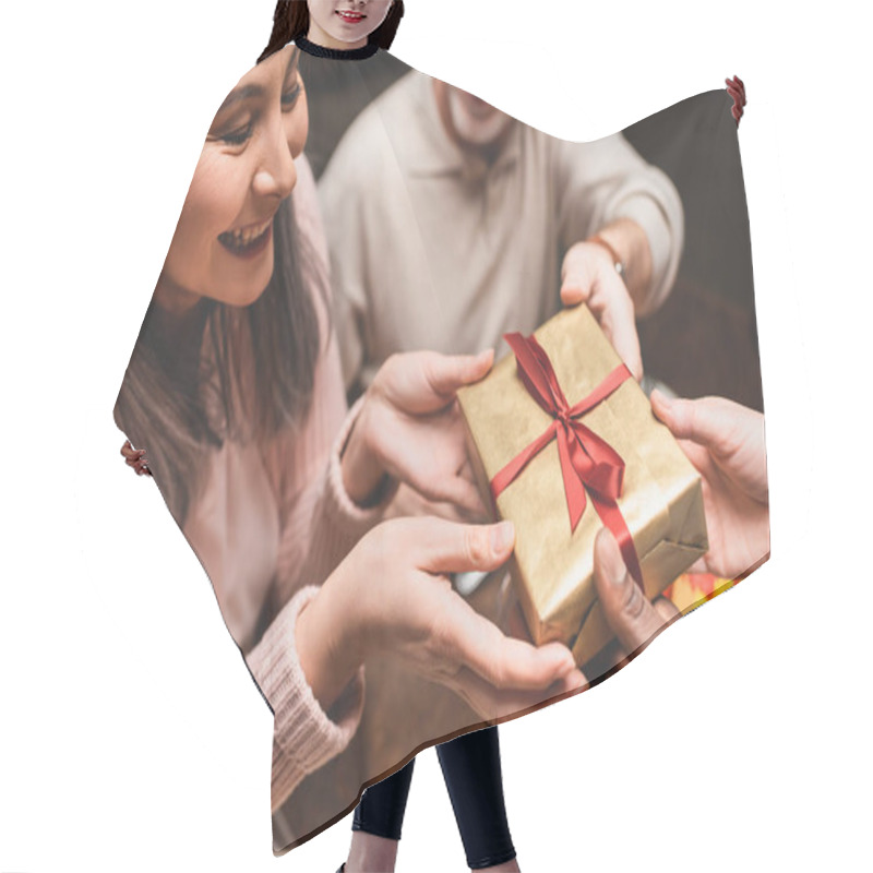 Personality  Cropped View Of Multicultural Friends Giving Present To Smiling Asian Woman During Dinner  Hair Cutting Cape