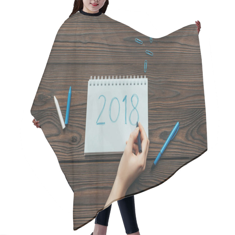 Personality  Cropped Shot Of Woman Writing 2018 In Notebook With Clips And Pencils Around On Wooden Surface Hair Cutting Cape