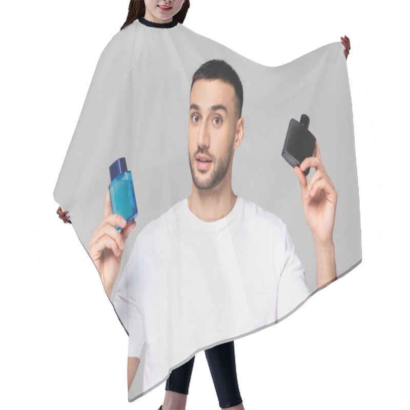 Personality  Young Hispanic Man In White T-shirt Holding Bottles Of Cologne Water Isolated On Grey Hair Cutting Cape