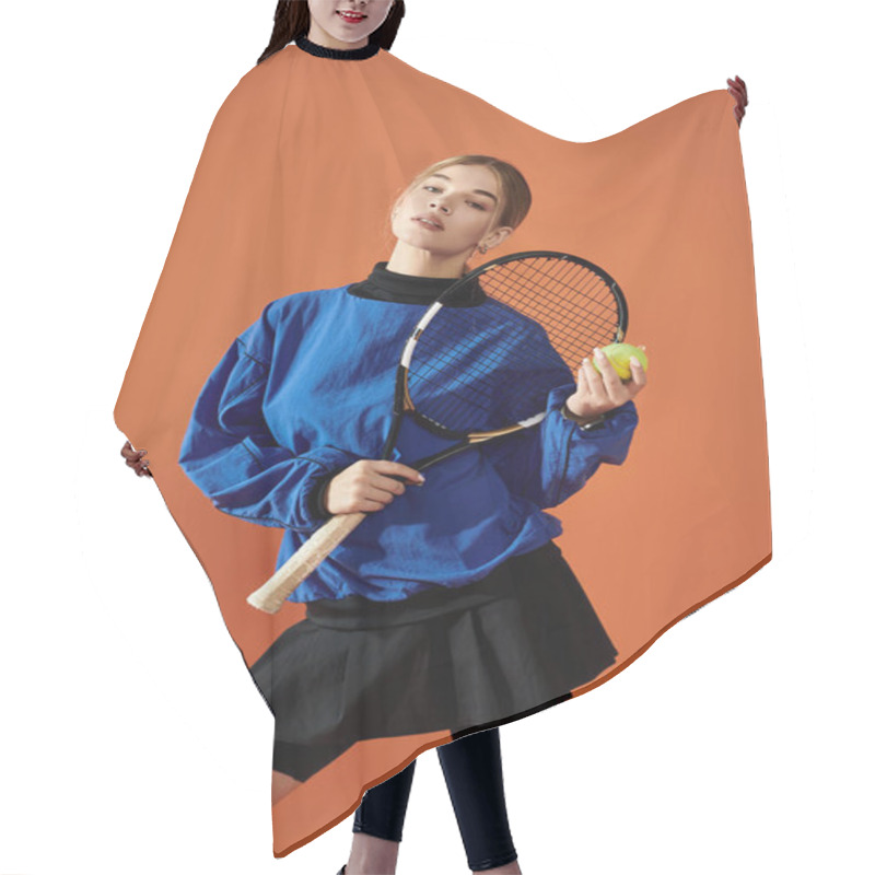 Personality  A Passionate Athlete Poses With A Tennis Racquet And Ball Against A Bright Orange Background. Hair Cutting Cape