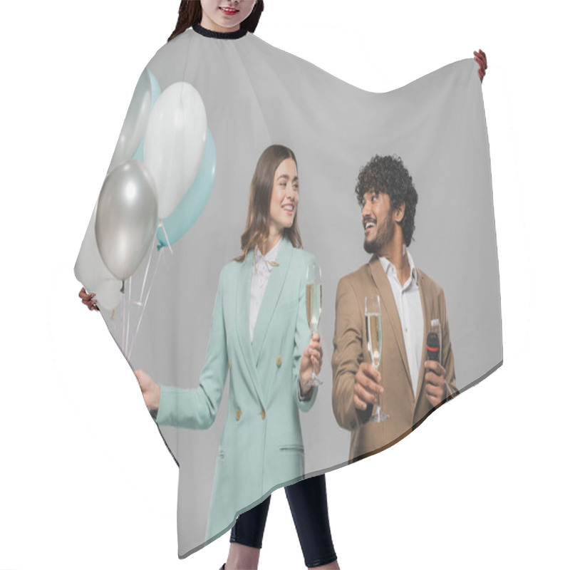 Personality  Positive Interracial Event Hosts In Formal Wear With Microphone And Festive Balloons Holding Champagne Glasses And Looking At Each Other Isolated On Grey   Hair Cutting Cape