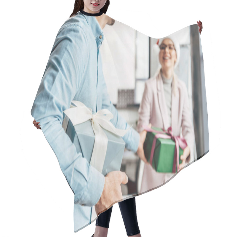 Personality  Cropped Shot Of Young Businessman Presenting Christmas Gift To Female Colleague In Office  Hair Cutting Cape