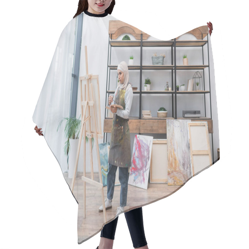 Personality  Full Length View Of Muslim Woman Drawing On Easel Near Painted Pictures In Home Studio Hair Cutting Cape