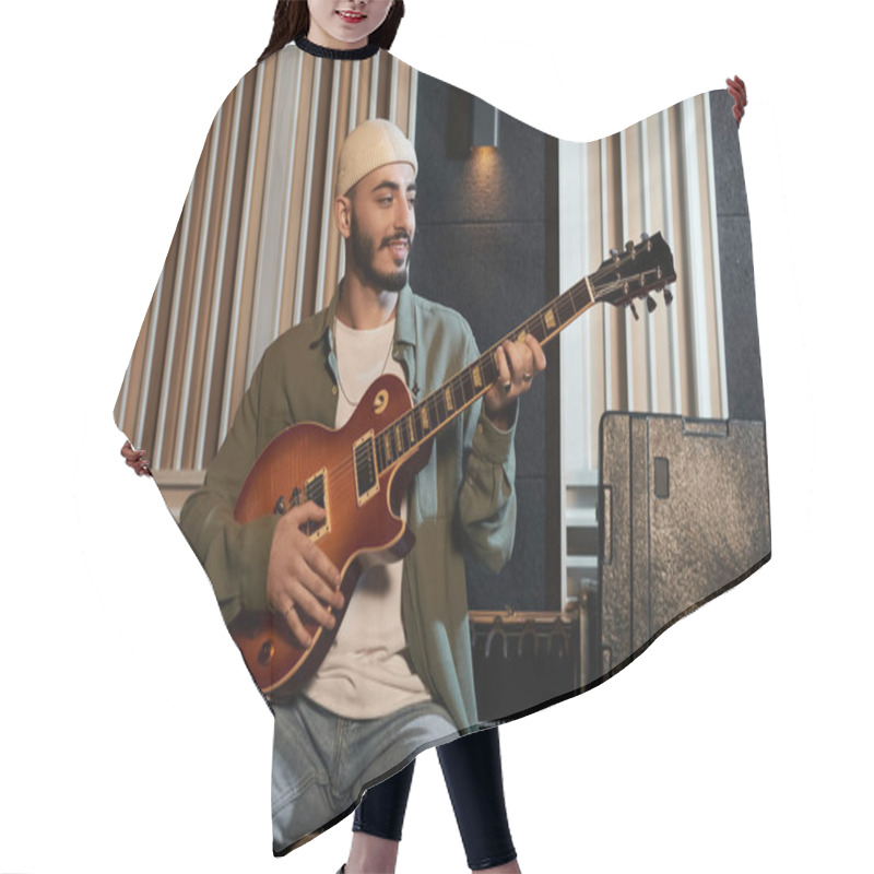 Personality  A Musician Strums A Guitar In A Recording Studio During A Music Band Rehearsal. Hair Cutting Cape