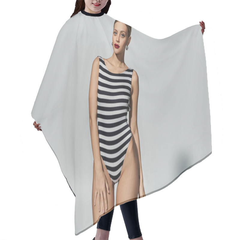 Personality  A Fashionable Blonde Woman Striking A Pose In A Chic, Black And White Striped Swimsuit. Hair Cutting Cape