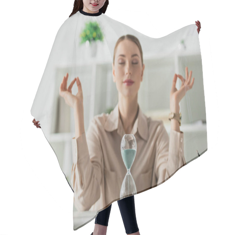 Personality  Selective Focus Of Businesswoman Meditating With Closed Eyes And Gyan Mudra At Workplace With Buddha Head, Sand Clock And Incense Stick Hair Cutting Cape