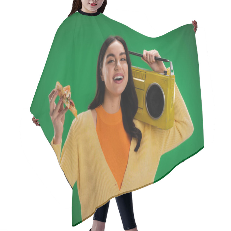 Personality  Joyful Woman With Piece Of Delicious Pizza And Boombox Looking At Camera Isolated On Green Hair Cutting Cape