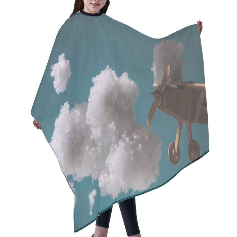 Personality  Wooden Toy Plane Flying Among White Fluffy Clouds Made Of Cotton Wool In Dark Hair Cutting Cape