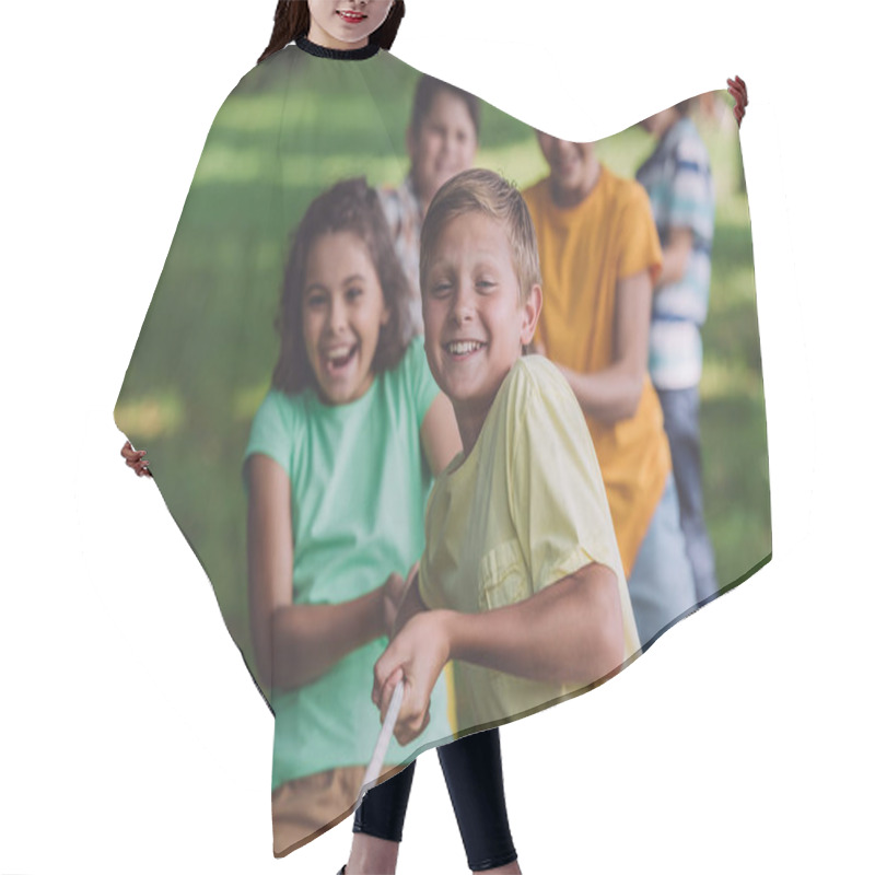 Personality  Selective Focus Of Happy Kids Competing In Tug Of War  Hair Cutting Cape