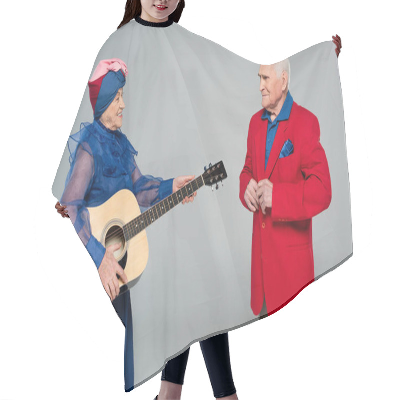 Personality  Smiling Elderly Woman In Blue Dress And Turban Holding Acoustic Guitar Near Man In Red Blazer Isolated On Grey Hair Cutting Cape