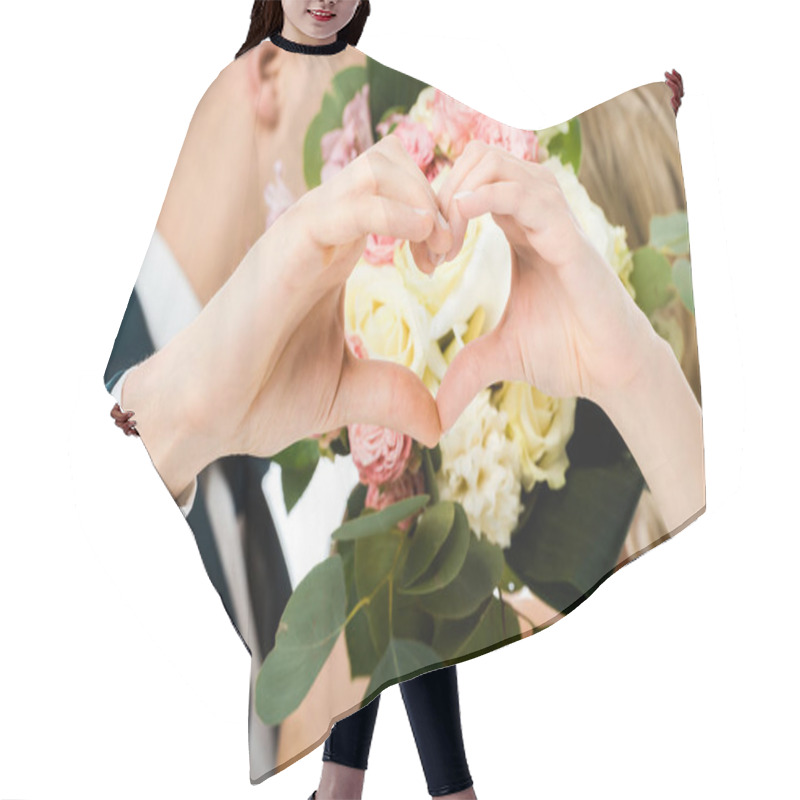 Personality  Selective Focus Of Groom And Bride Showing Heart Sign With Hands, While Hiding Faces Behind Wedding Bouquet Isolated On White Hair Cutting Cape