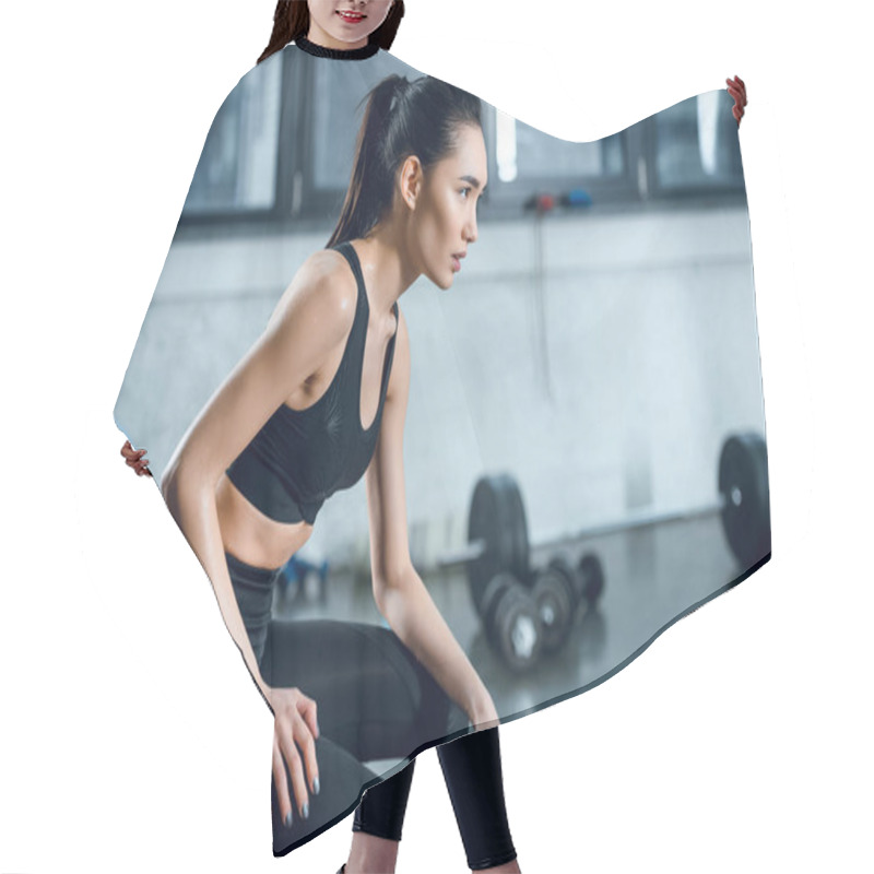 Personality  Side View Of Attractive Fit Woman Sitting On Workout Wheel After Training At Gym Hair Cutting Cape