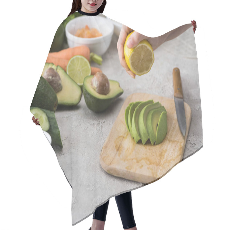 Personality  Cropped View Of Woman Squeezing Lemon On Cut Avocado On Cutting Board  Hair Cutting Cape