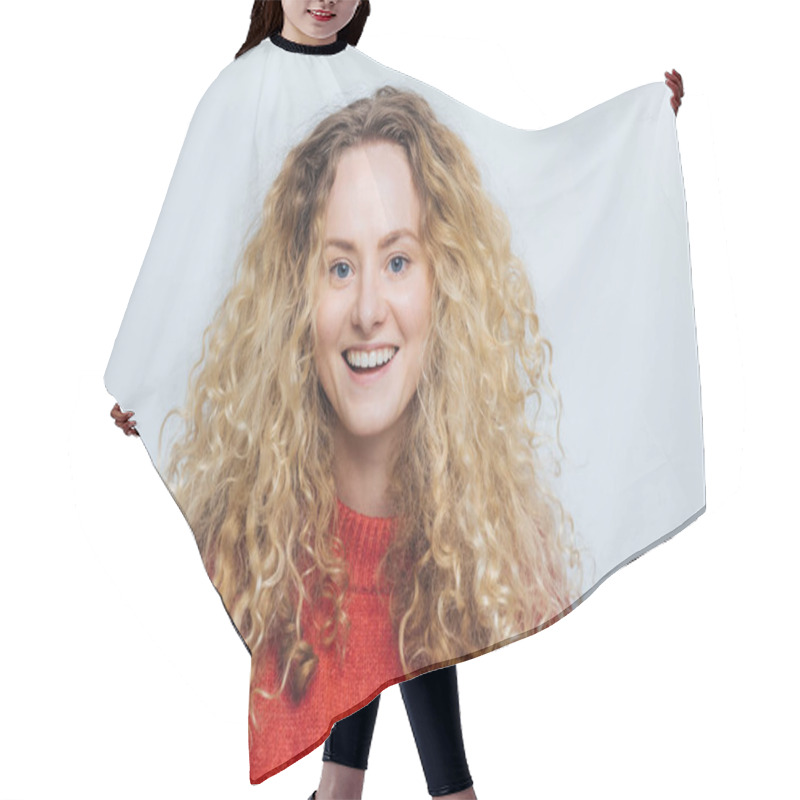 Personality  Isolated Shot Of Attractive Glad Blonde Gorgeous Female Has Curly Hair, Has Broad Smile, Being In High Spirit After Successful Day, Poses Against Blank White Studio Background. Delighted Young Woman Hair Cutting Cape