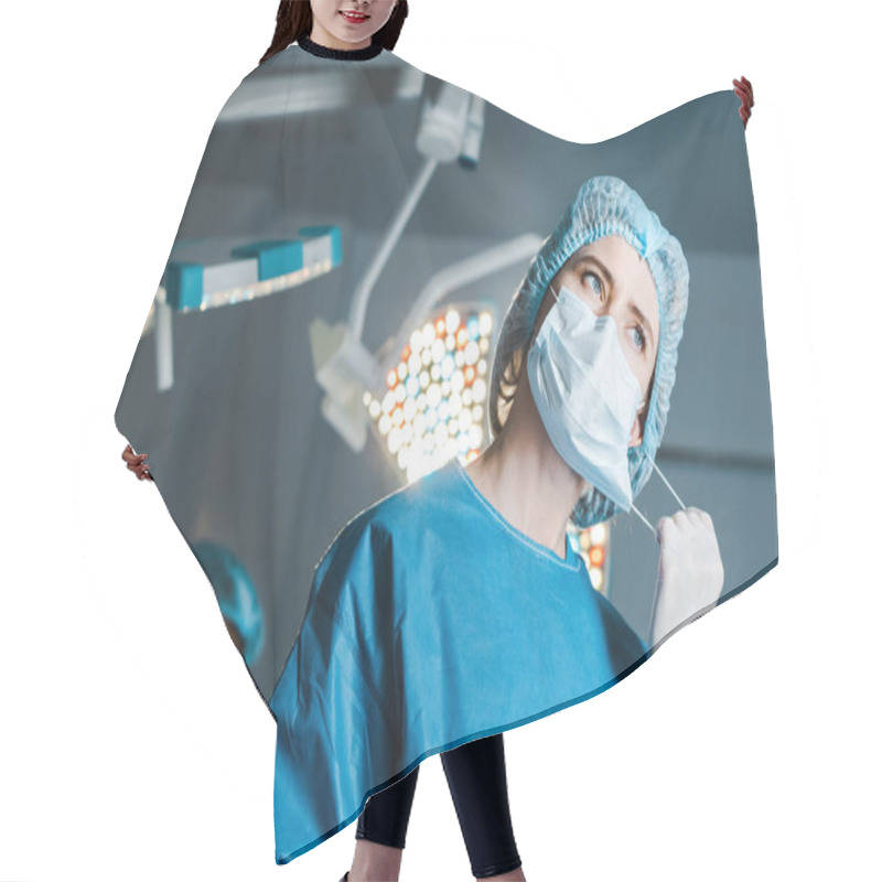 Personality  Selective Focus Of Nurse In Uniform Putting Off Medical Mask In Operating Room Hair Cutting Cape