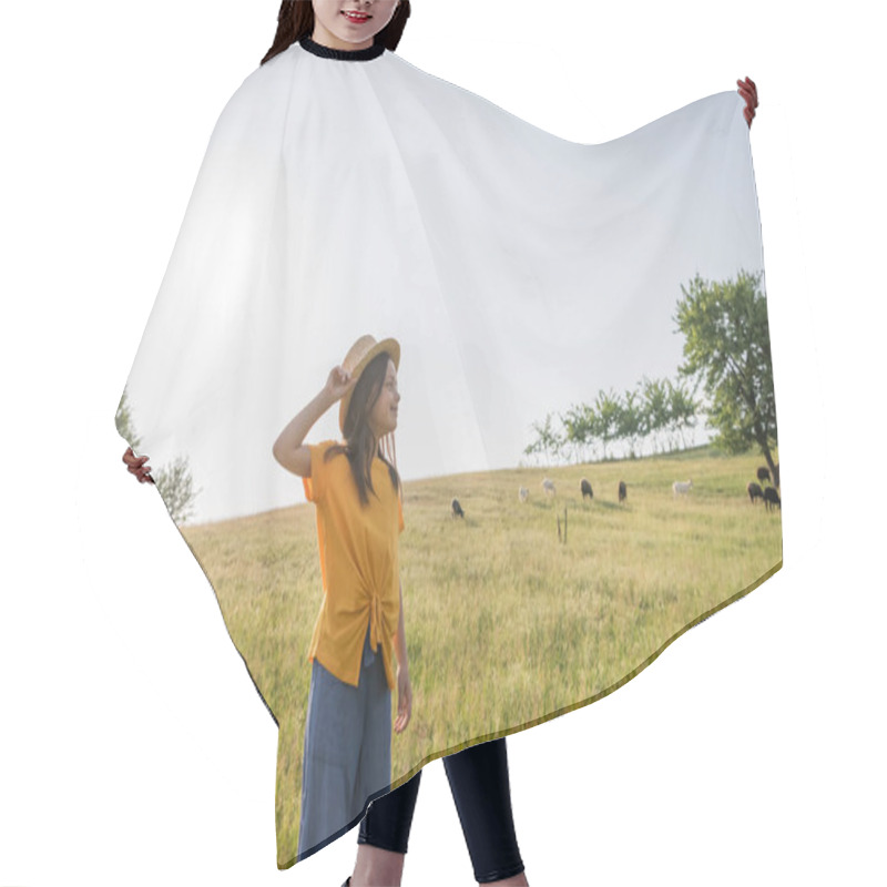 Personality  Happy Child Adjusting Straw Hat And Looking Away In Scenic Meadow Near Grazing Flock Hair Cutting Cape