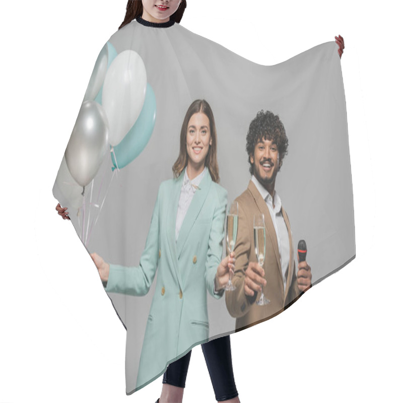 Personality  Smiling Multiethnic Event Hosts In Formal Wear Holding Festive Balloons, Microphone And Glasses Champagne While Looking At Camera During Party Isolated On Grey   Hair Cutting Cape