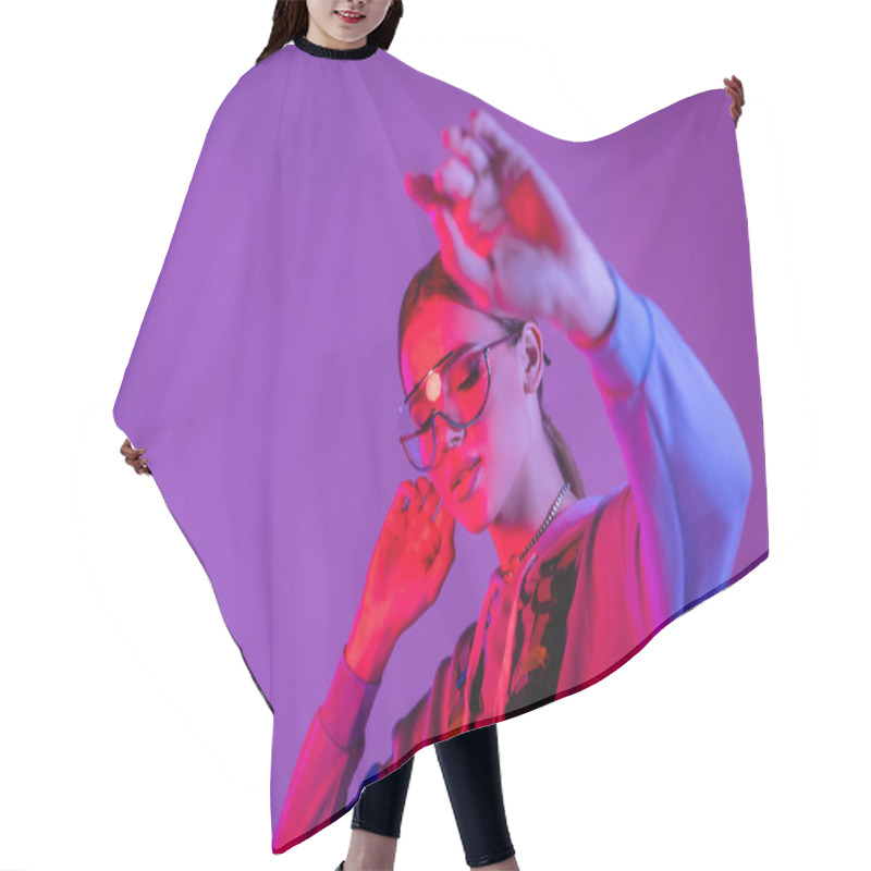 Personality  Stylish Woman In Sunglasses With Outstretched Hand On Blurred Foreground Isolated On Purple  Hair Cutting Cape