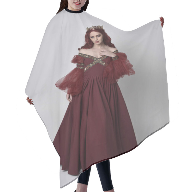 Personality  Portrait Of A Beautiful Woman With Red Hair Wearing  A  Flowing Burgundy Fantasy Gown And Golden Crown.  Full Length Standing Pose, Isolated Against A Studio Background Hair Cutting Cape