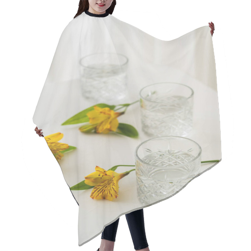 Personality  Crystal Glasses With Water Near Yellow Alstroemeria Flowers On White Tabletop And Blurred Background  Hair Cutting Cape