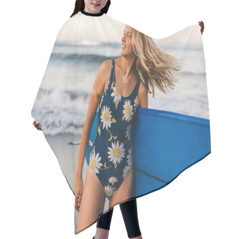 Personality  Portrait Of Young Attractive Sportswoman In Swimming Suit With Blue Surfing Board On Coastline Hair Cutting Cape