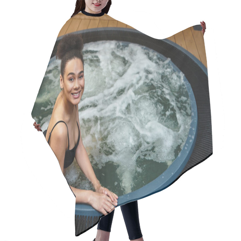 Personality  A Young African American Woman Smiles Joyfully While Enjoying A Soothing Soak In Warm Waters. Hair Cutting Cape